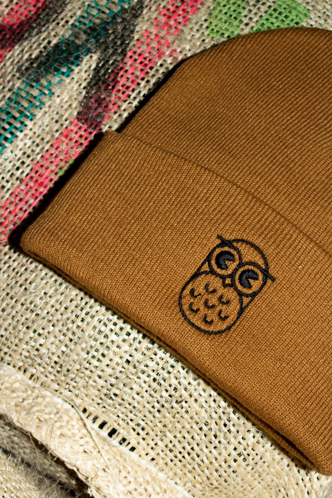 Caramel Leo Beanie with black embroidered owl on a coffee sack
